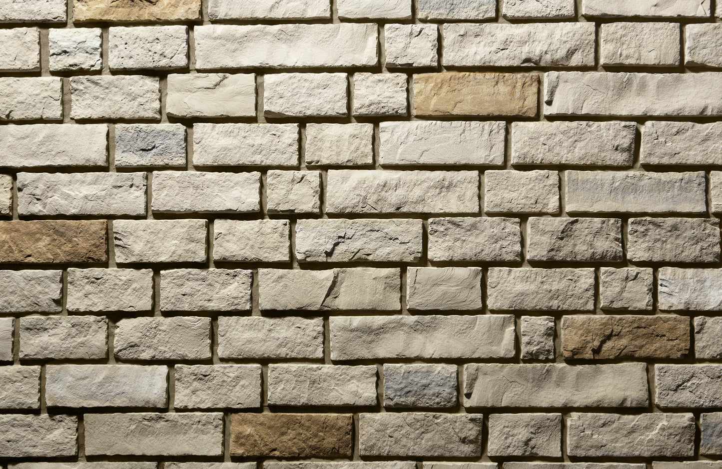 Pattern of stone bricks in various shades of brown and beige.