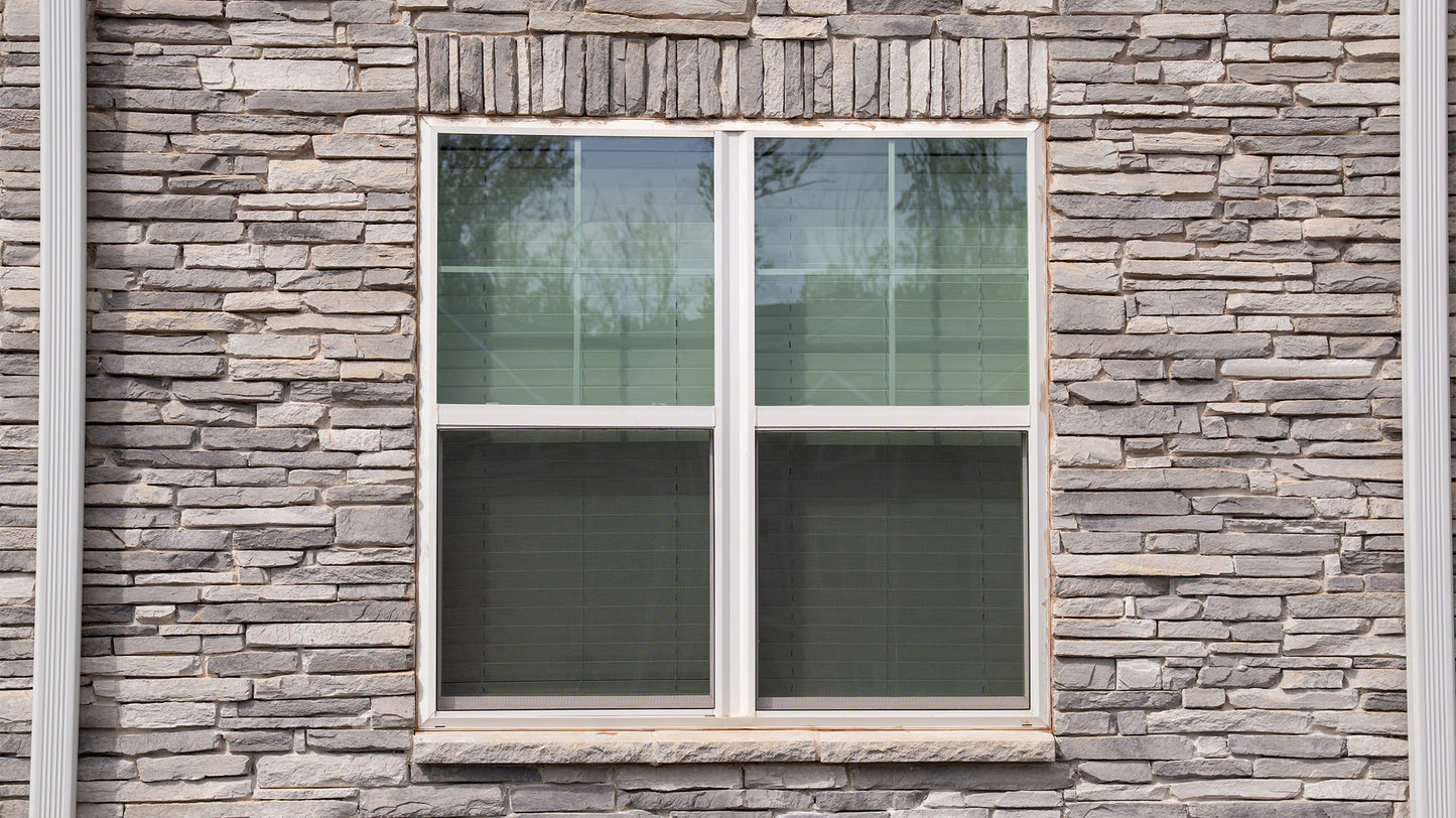 Window with white frame on a stone wall