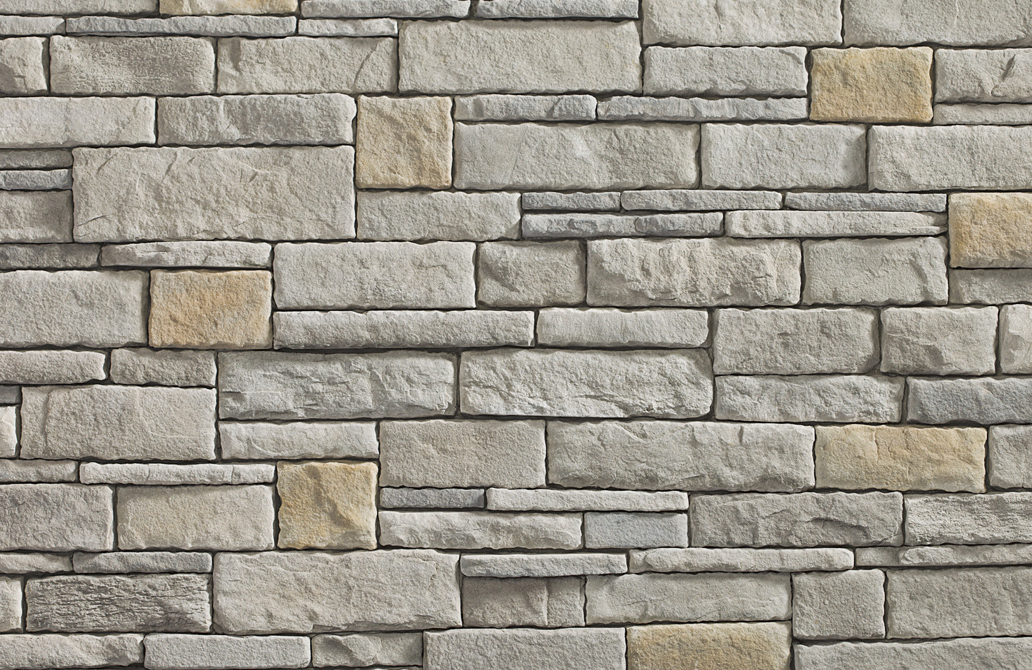 Pattern of stone bricks in various shades of gray and beige.