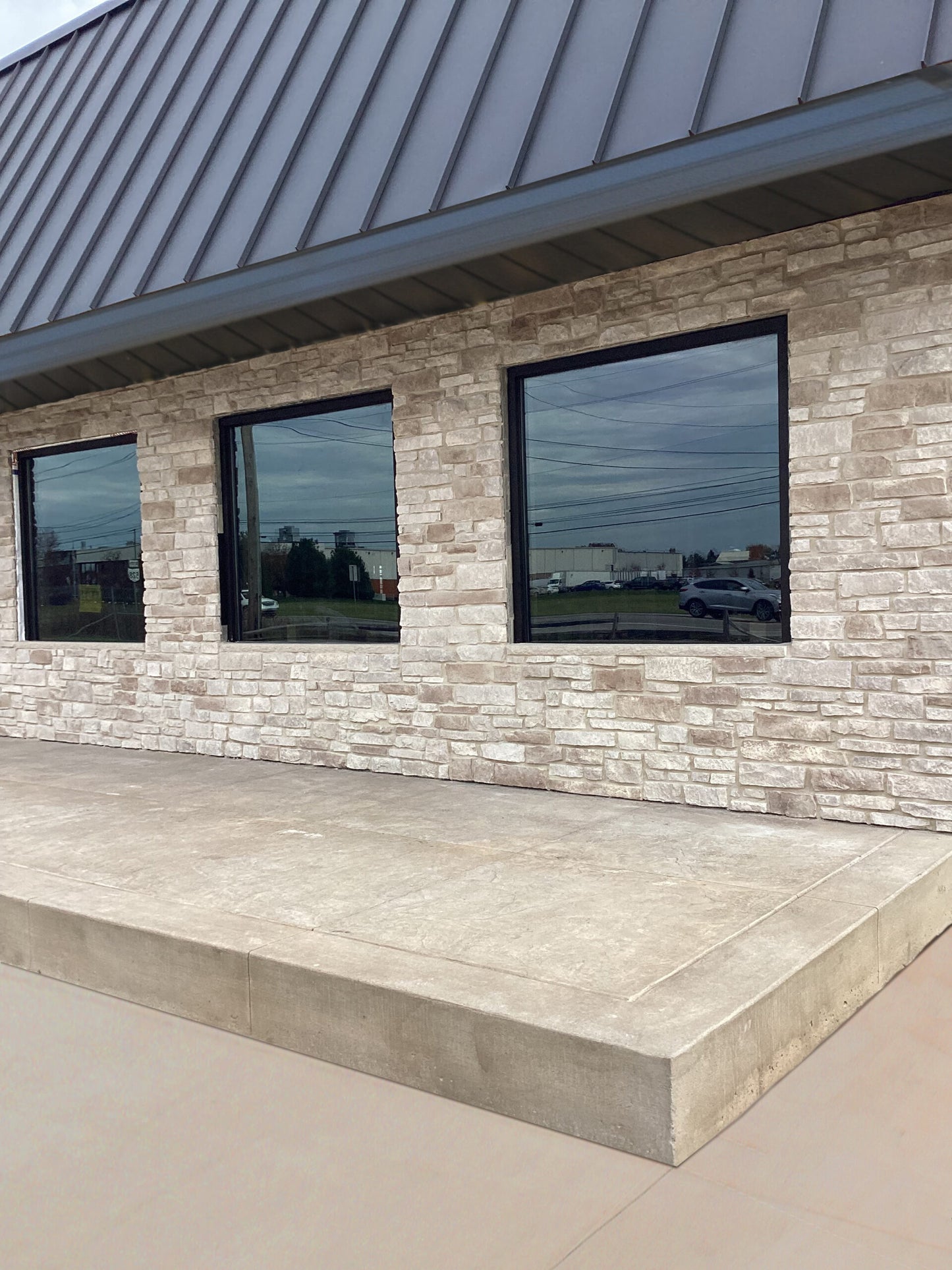 Building exterior with stone facade and large windows