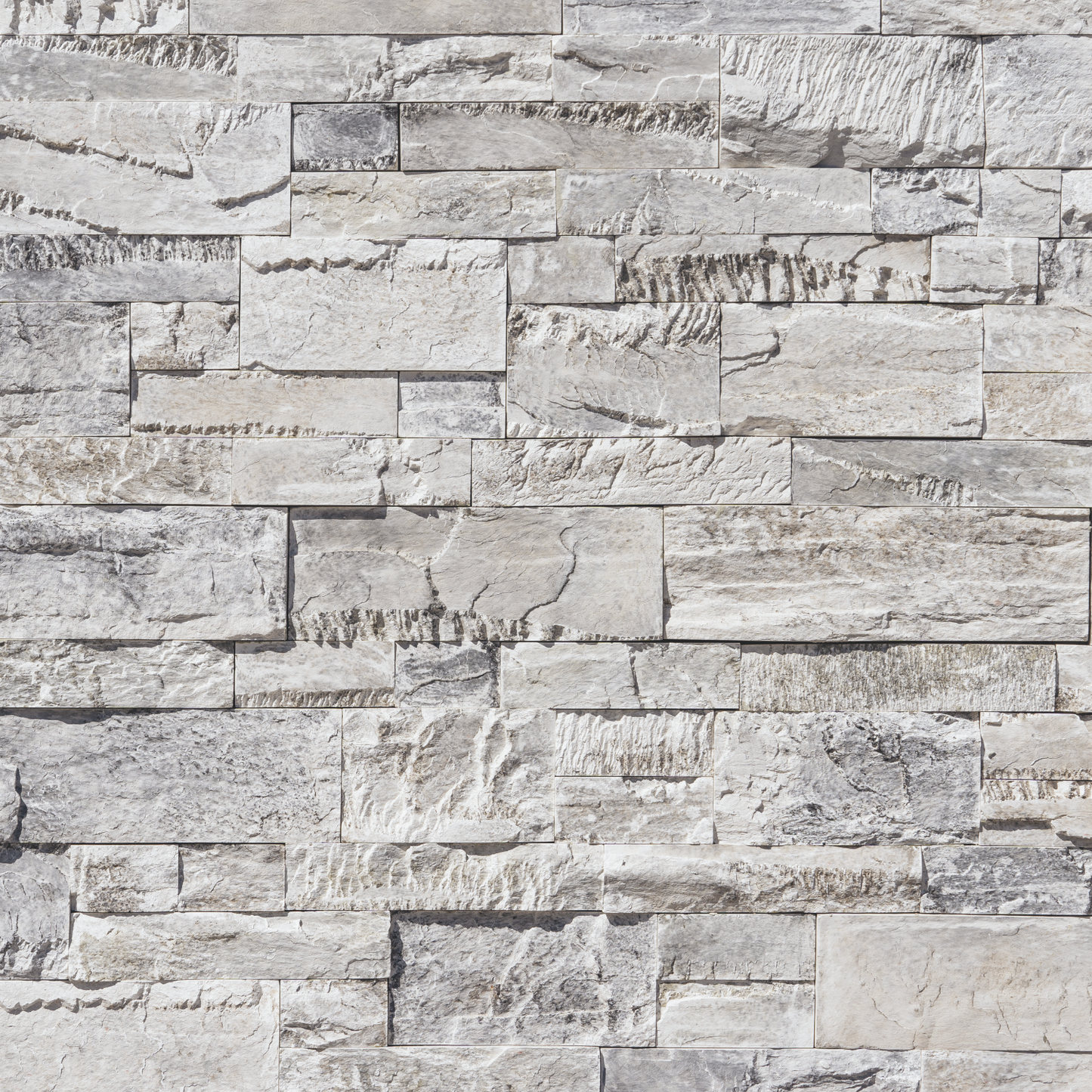 Textured stone wall panel with varying shades of gray and beige.