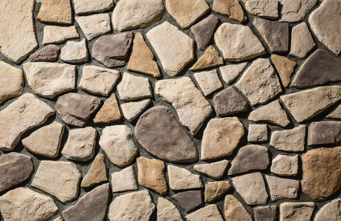 Close-up of a stone wall with various colored stones