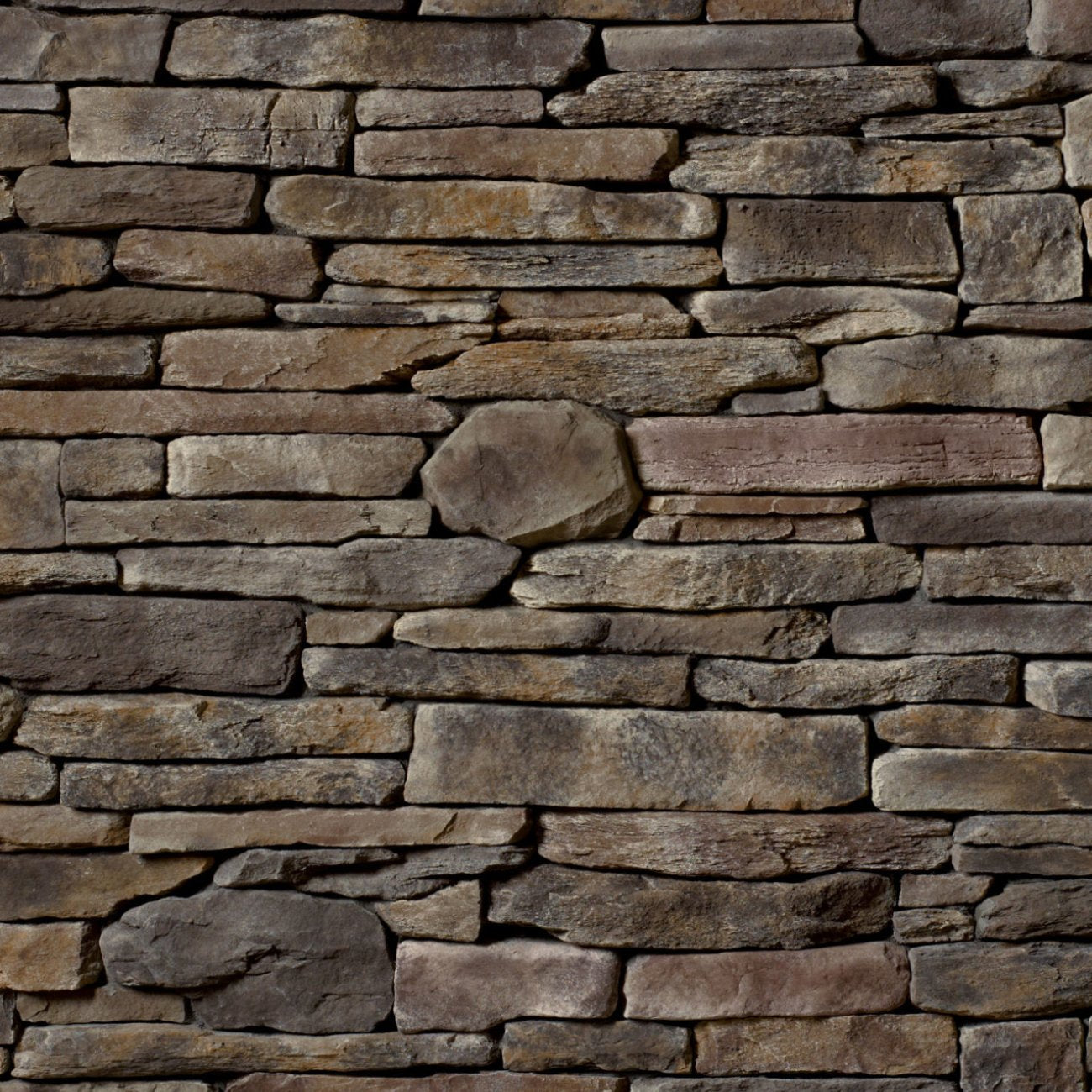 Cultured Stone Wolf Creek Southern Ledgestone veneer featuring warm brown and gray tones, layered stacked stone texture, and natural stone depth
