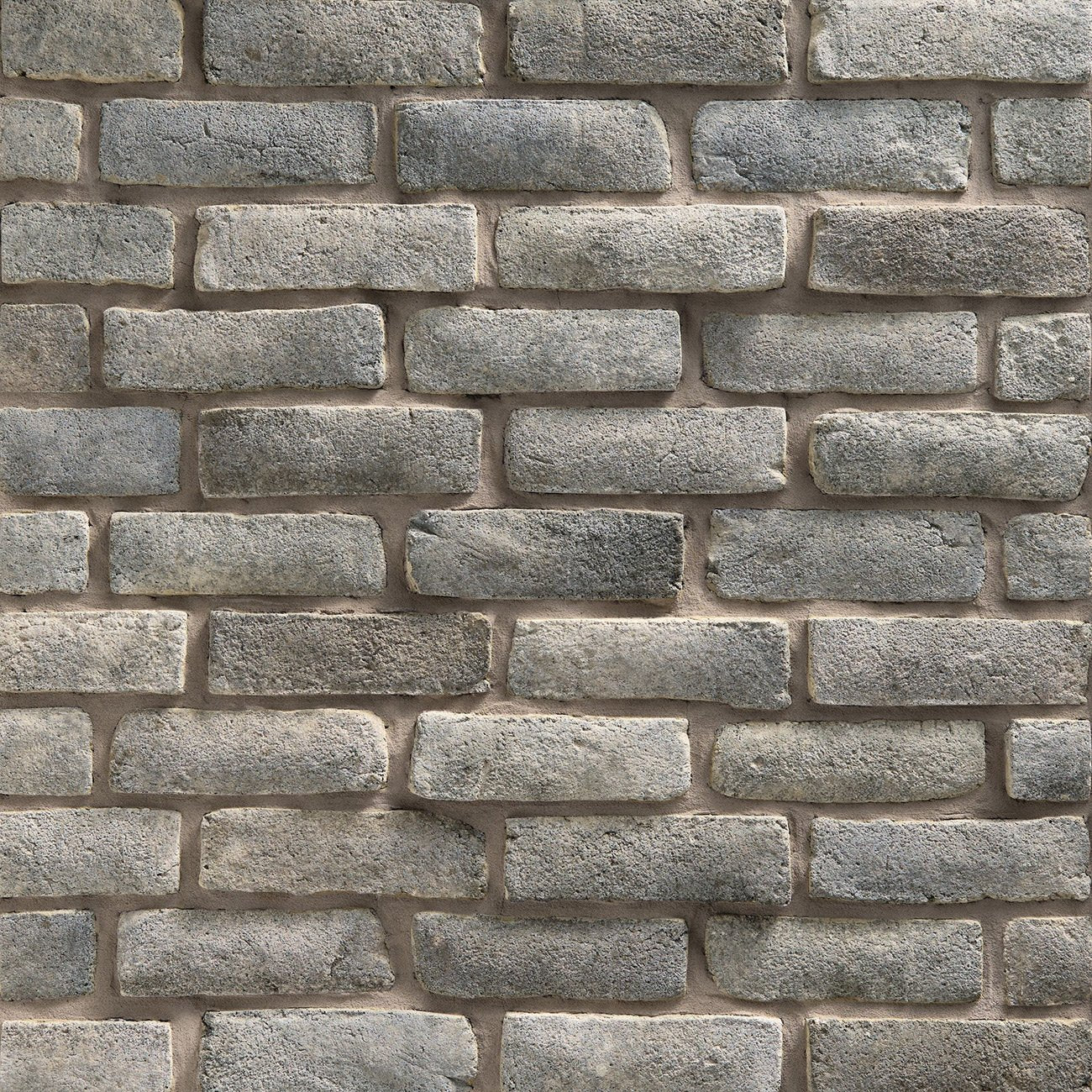 Dutch Quality Quail Grey Handformed Brick veneer featuring soft gray tones, handcrafted texture, and natural artisan brick detailing