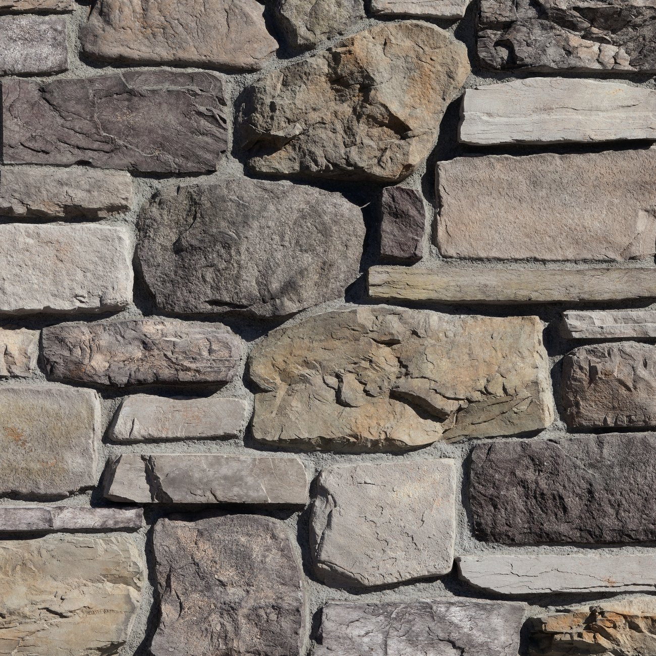 Eldorado Catania Cypress Ridge stone veneer in warm brown and gray hues with rugged, hand-hewn stone texture