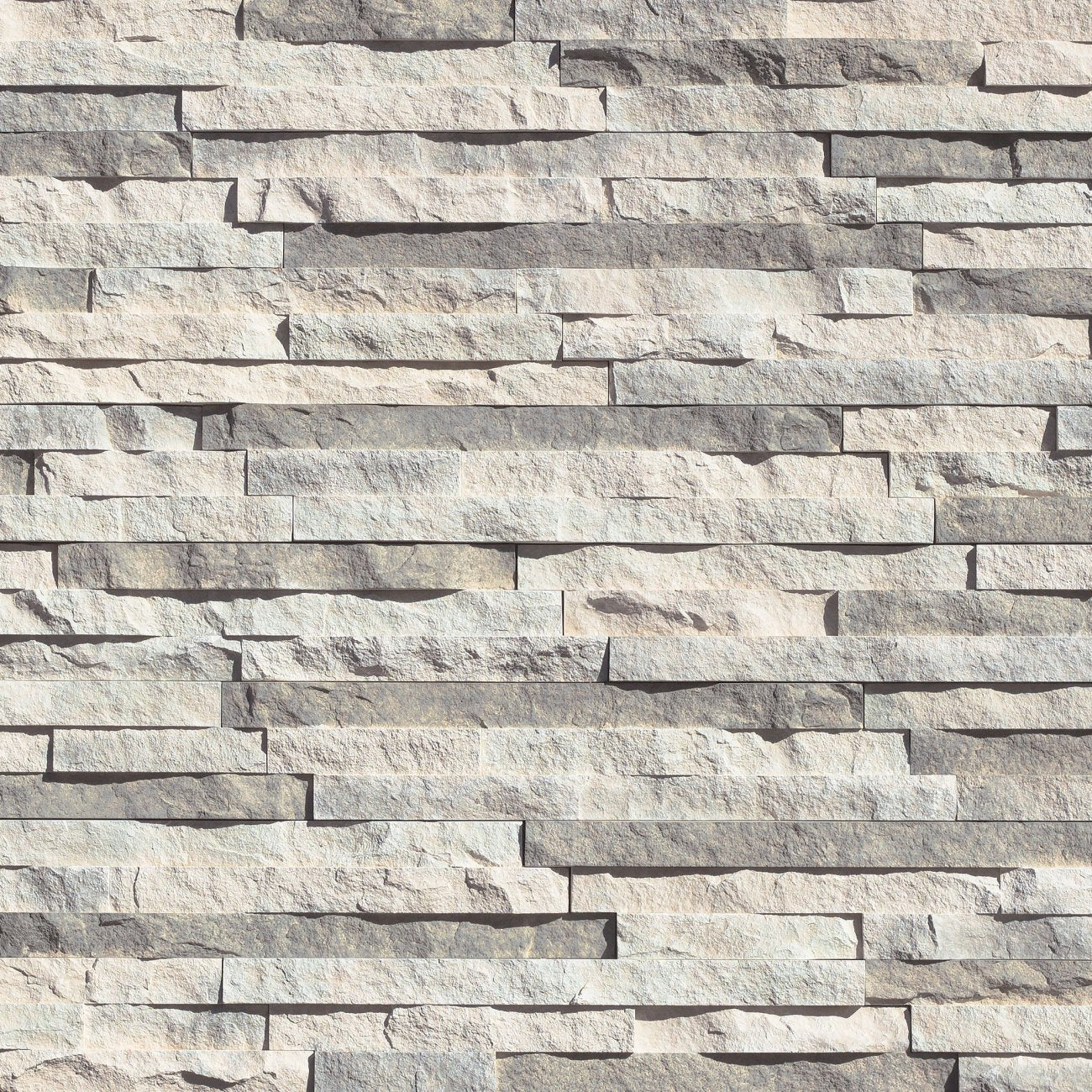 Eldorado Glacier European Ledge stone veneer in cool gray and white hues with linear, chiseled stone texture