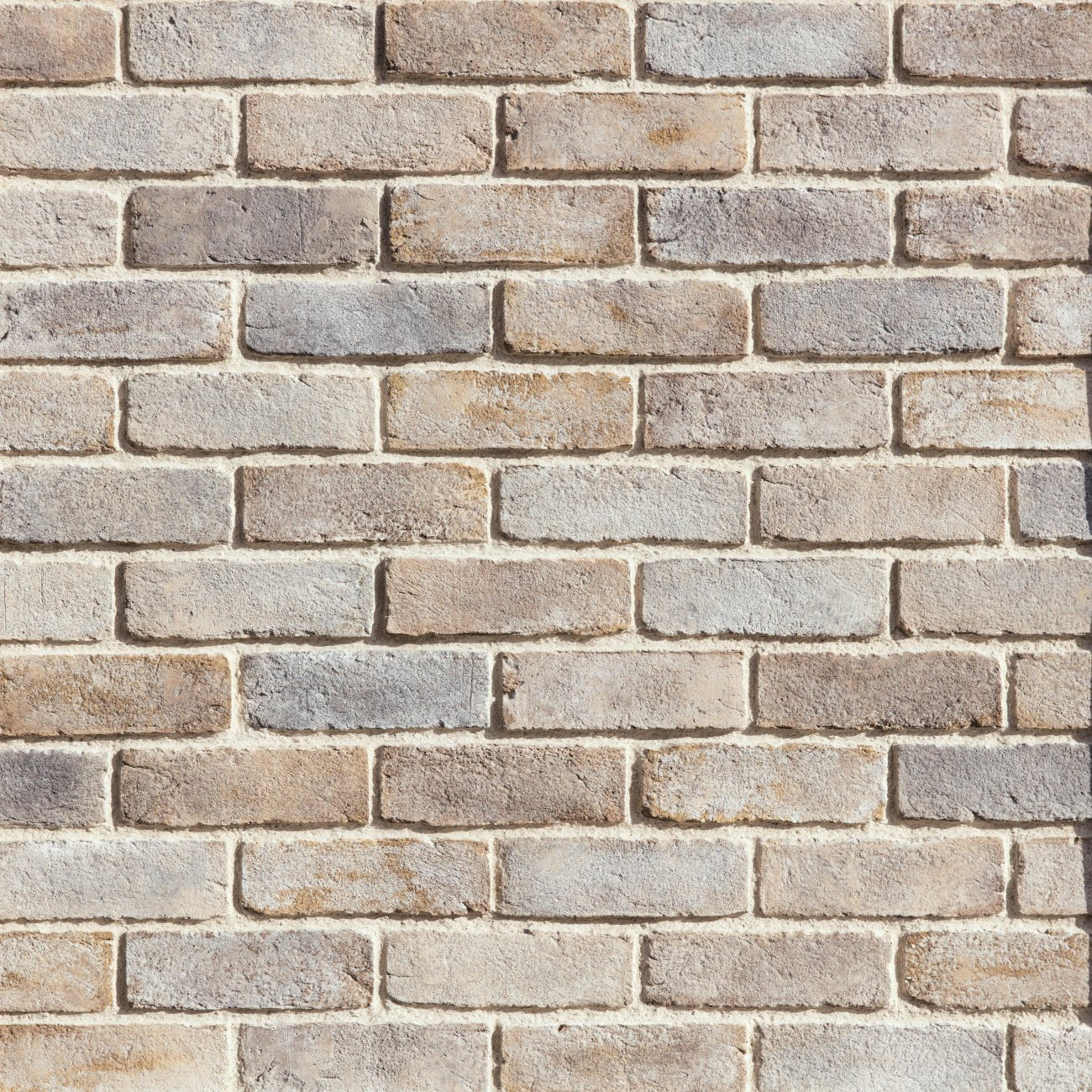 Eldorado Latigo TundraBrick thin brick-style stone veneer in warm brown, tan, and taupe tones with subtle texture