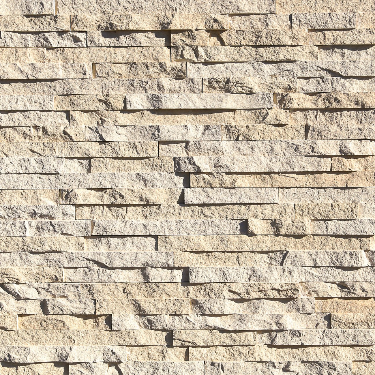 Eldorado Linen European Ledge stone veneer in soft white and cream hues with linear, chiseled stone texture