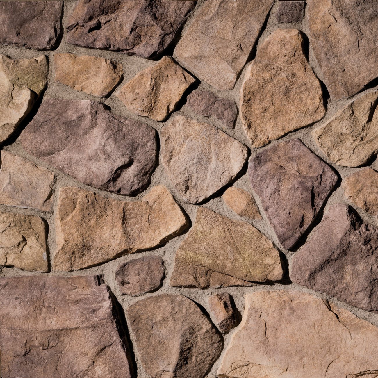 Eldorado Millstream Country Rubble stone veneer in cool gray and taupe hues with rustic, irregular fieldstone texture