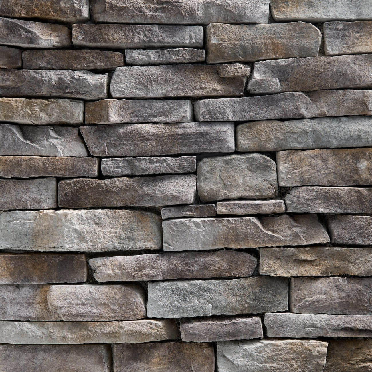 StoneCraft Mineral Ridge Ledgestone stone veneer featuring cool gray mineral tones, layered split-face texture, and dimensional stacked-stone character.