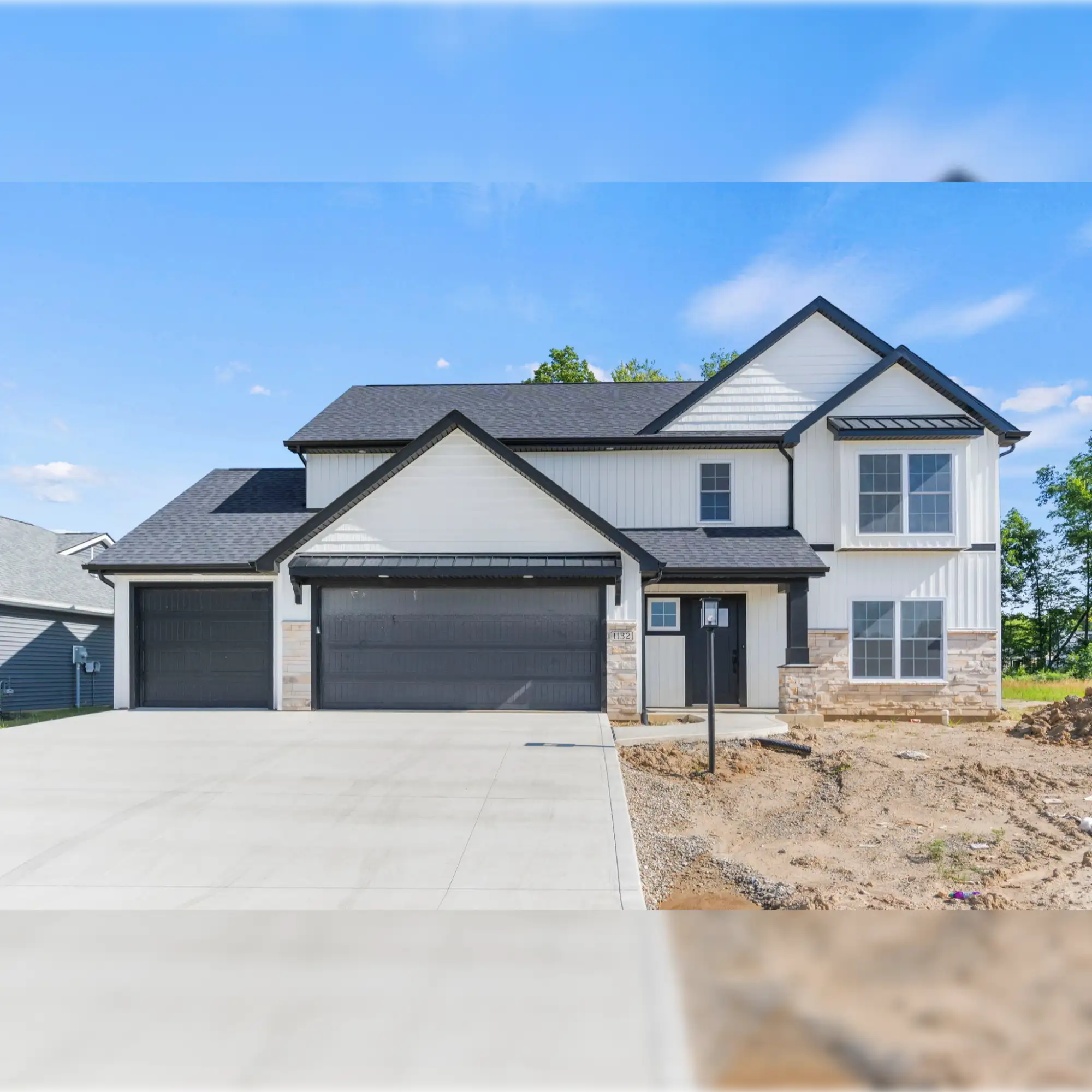 2-car garage with black doors and white siding.