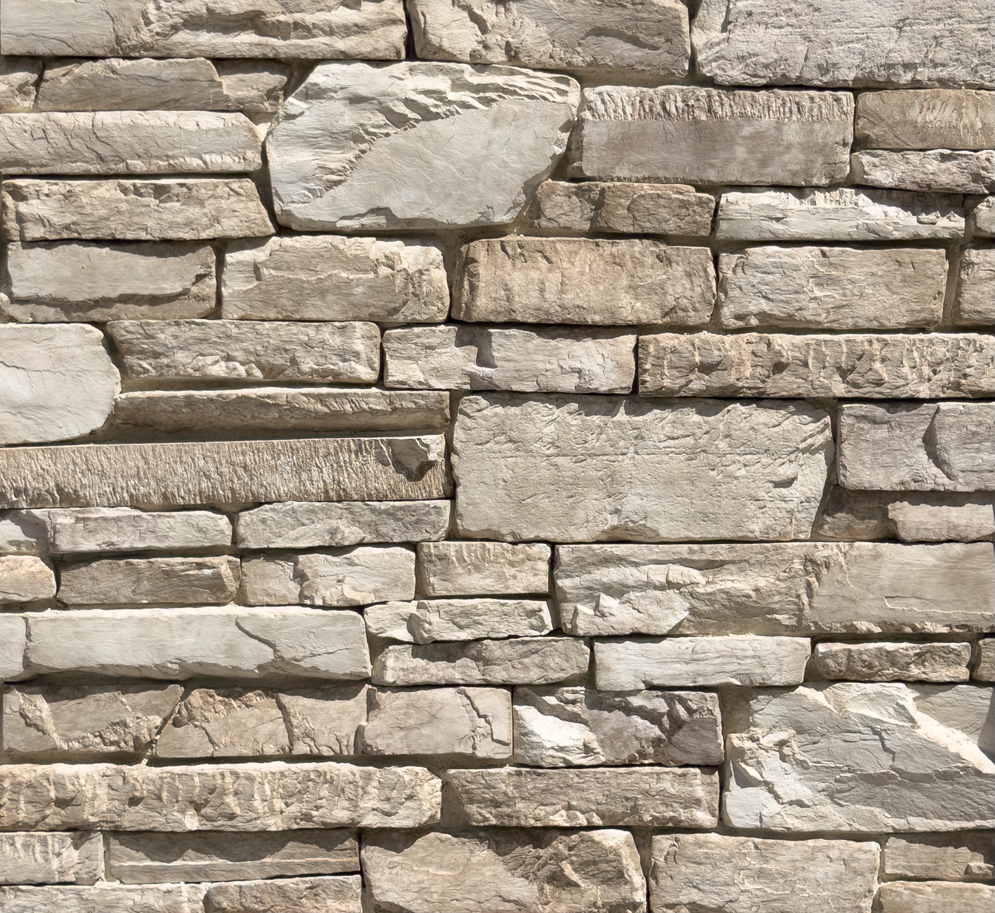 Close-up of a stone wall with varying stone sizes and colors.