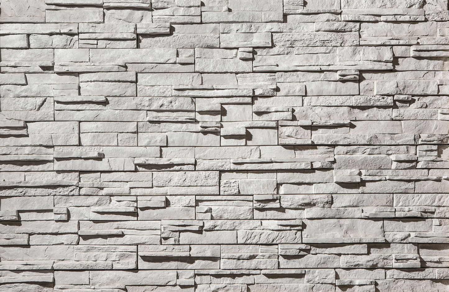 Textured stone wall with varying shades of gray