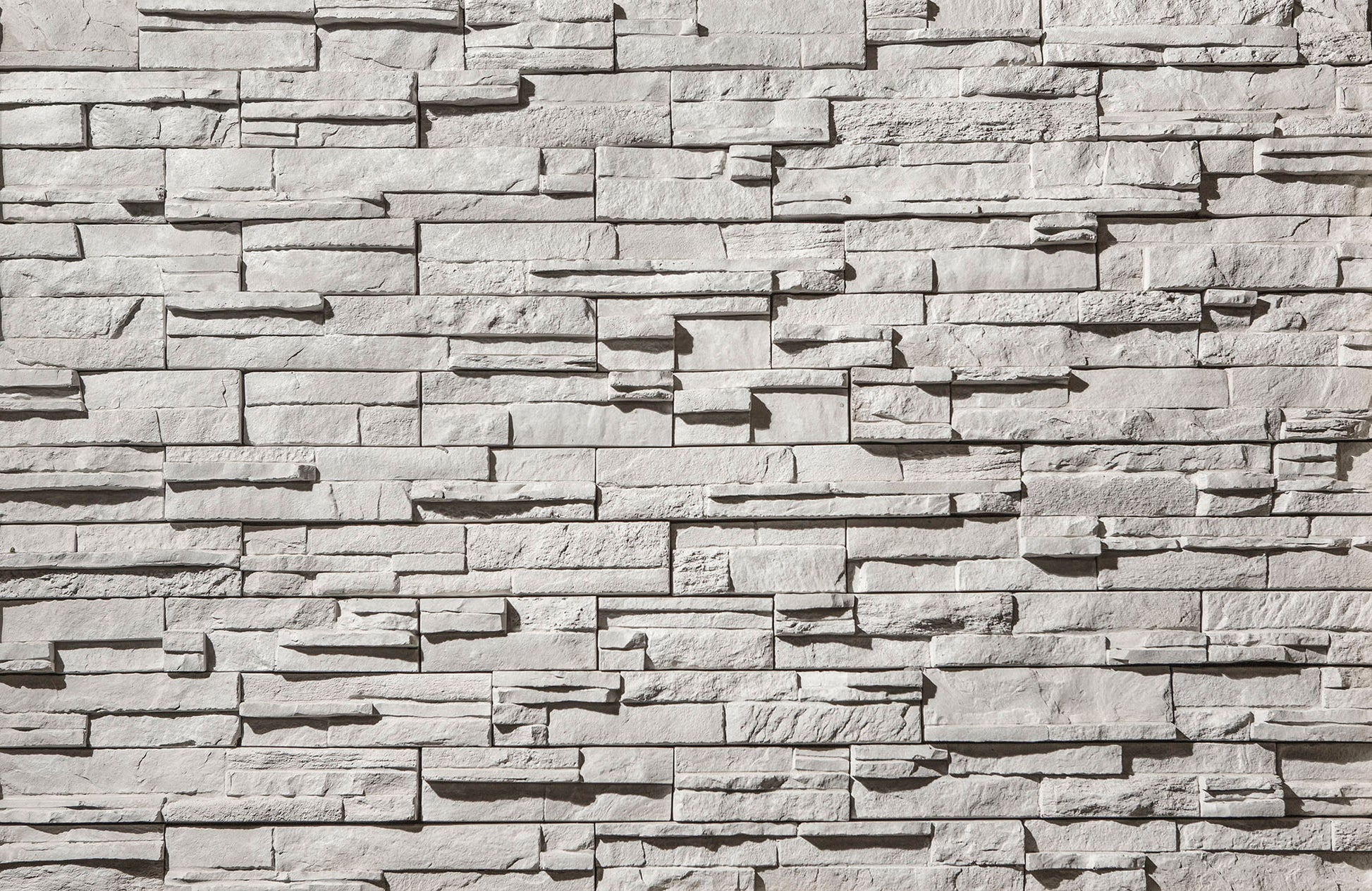 Textured stone wall with varying shades of gray