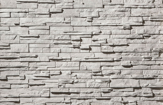 Textured stone wall with varying shades of gray