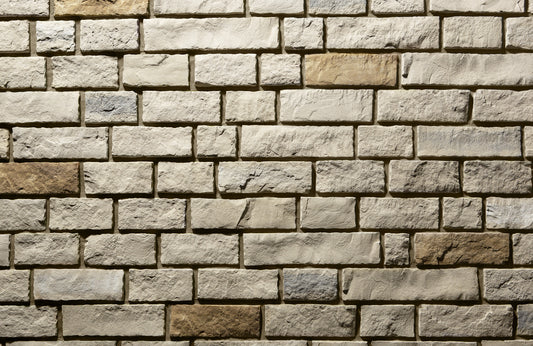 Pattern of stone bricks in various shades of brown and beige.