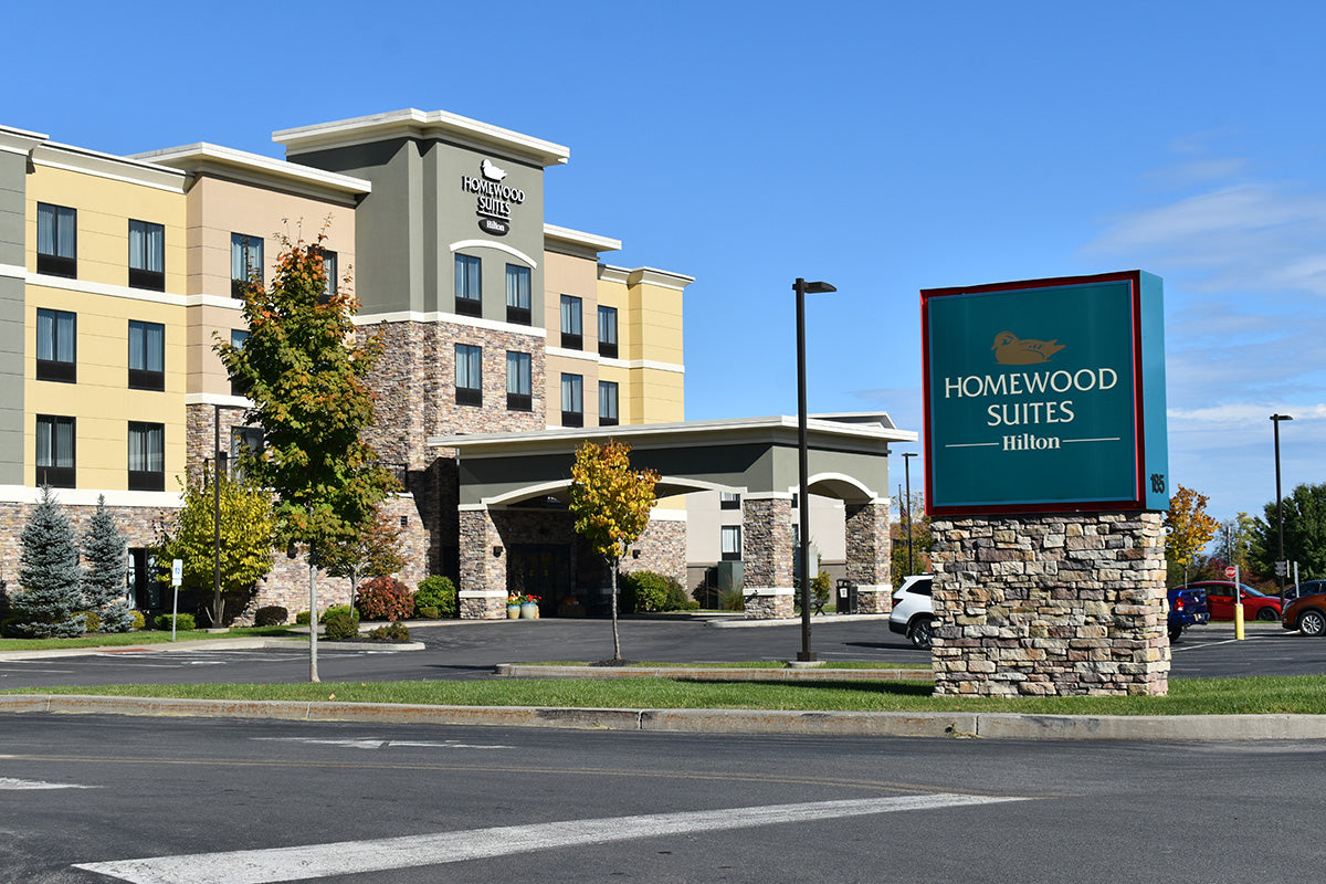 Homewood Suites by Hilton hotel entrance with sign in front