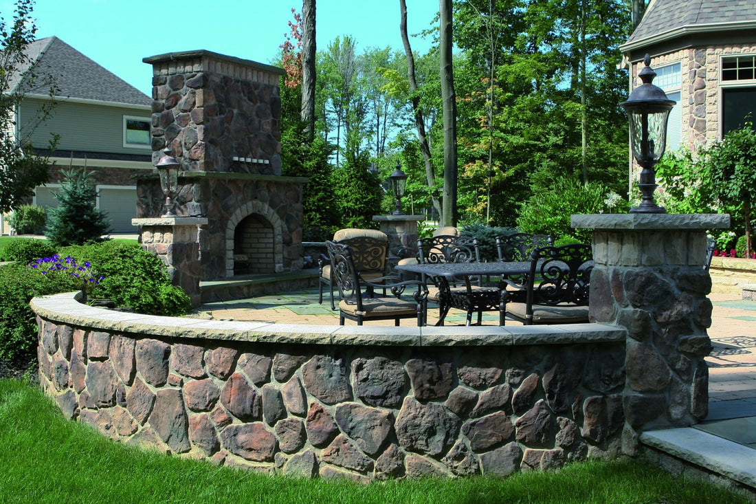 Fieldstone outdoor fireplace and curved low wall enclosing a landscaped patio, featuring Dutch Quality Pennsylvania Fieldstone.