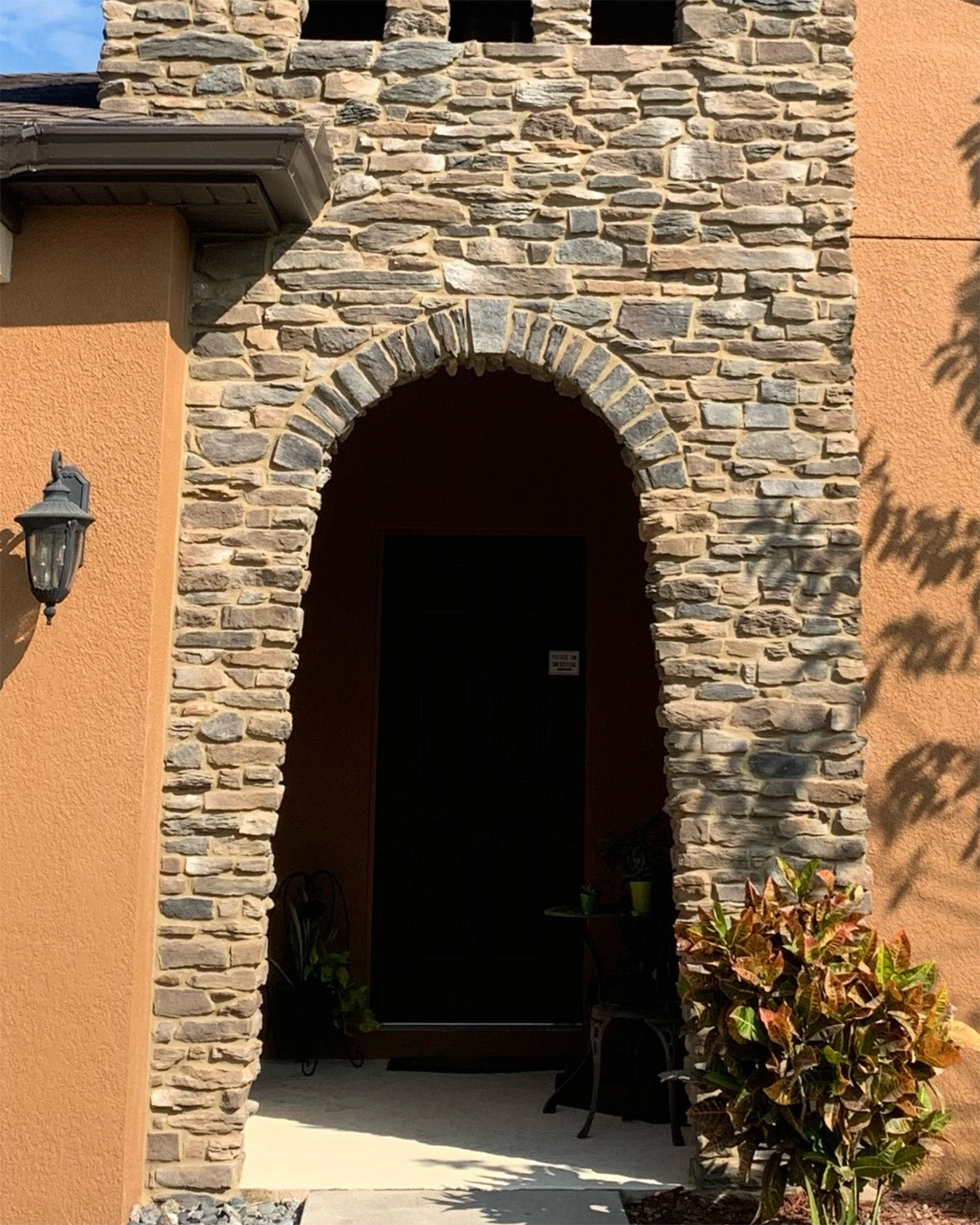 Stone archway entrance to a building with decorative elements.