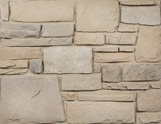 Close-up of a stone wall with beige and brown stones