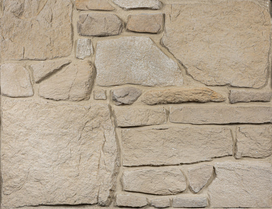 Close-up of a stone wall with varying stone sizes and colors.