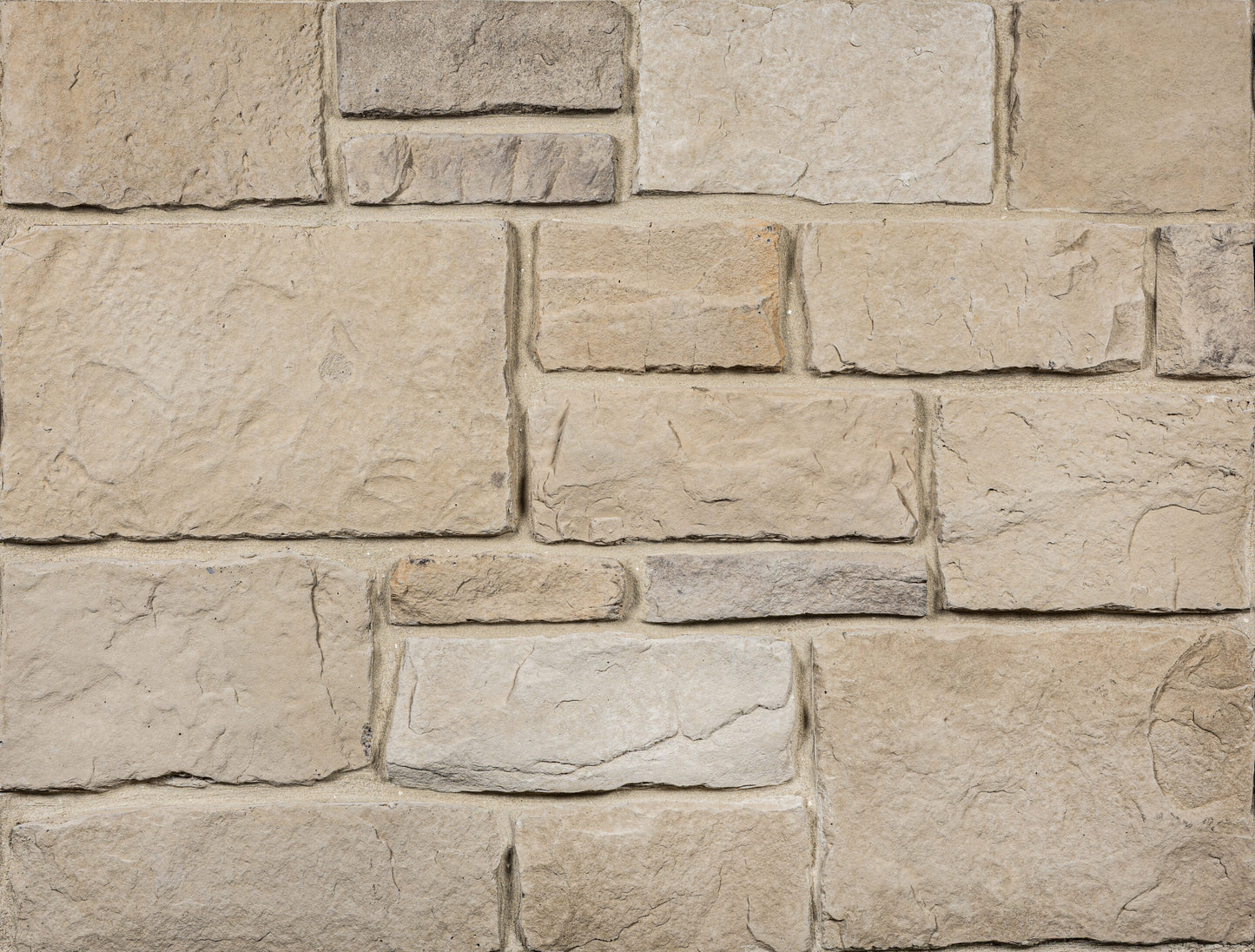 Close-up of a stone wall with beige and brown stones