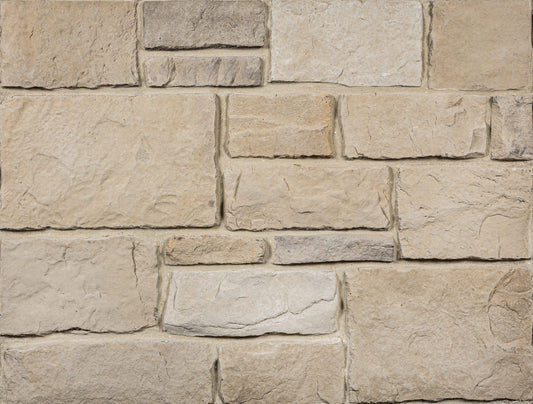 Close-up of a stone wall with beige and brown stones
