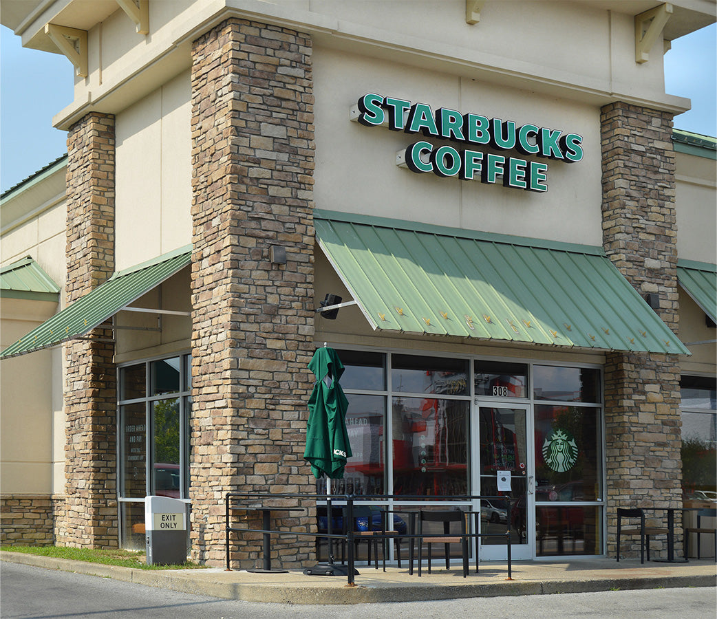 Starbucks Coffee shop exterior with stone facade and green awning