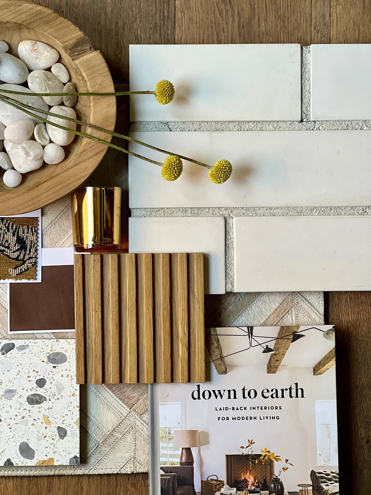 Collage of interior design elements with a book titled 'Down to Earth' on a wooden surface.