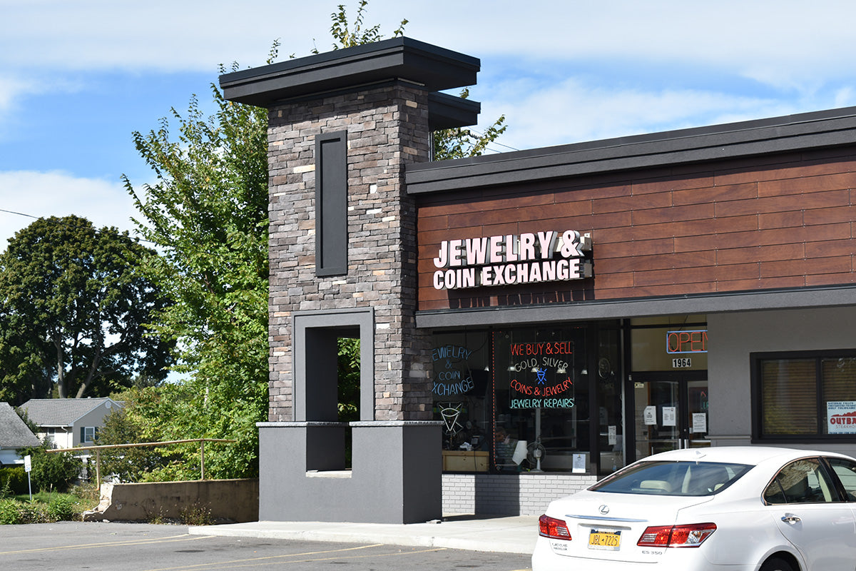 Storefront of Jewelry & Coin Exchange with a white car parked in front