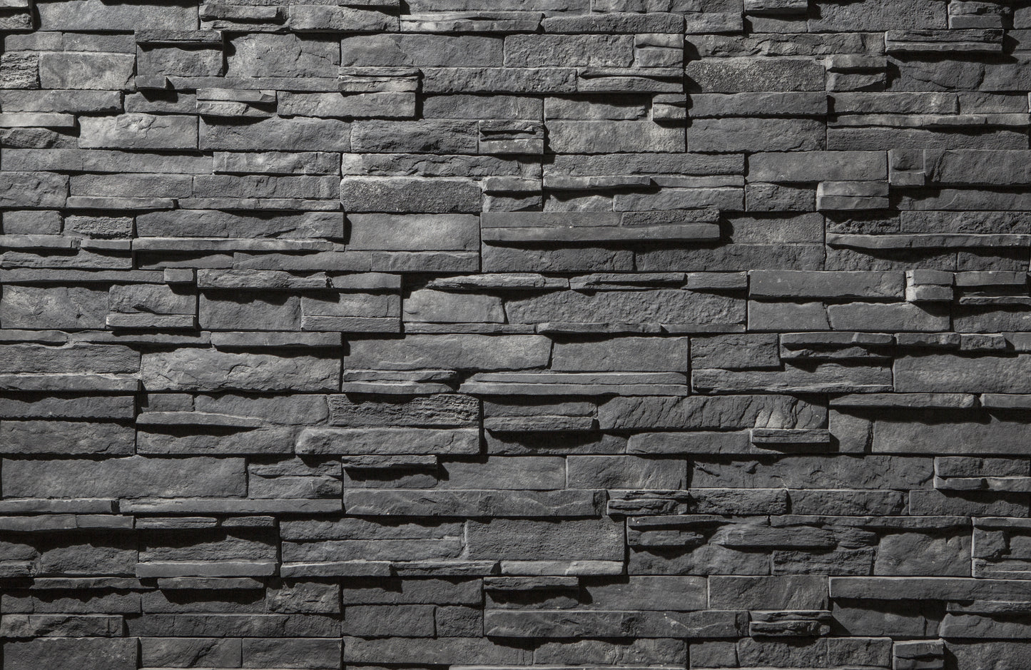 Textured stone wall with varying shades of gray