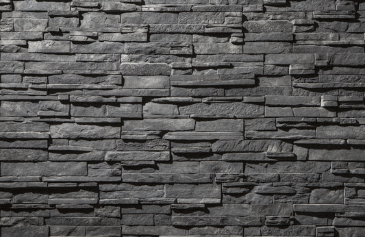 Textured stone wall with varying shades of gray
