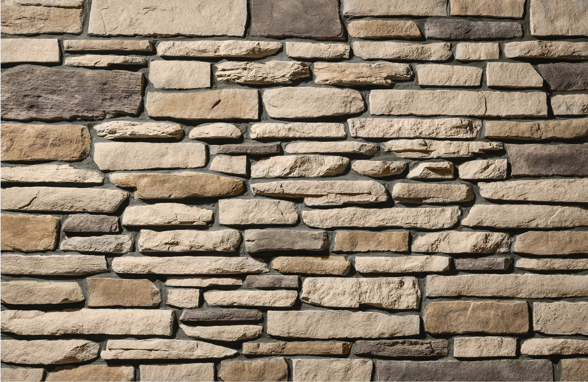 Close-up of a stone wall with various shades of brown and beige.