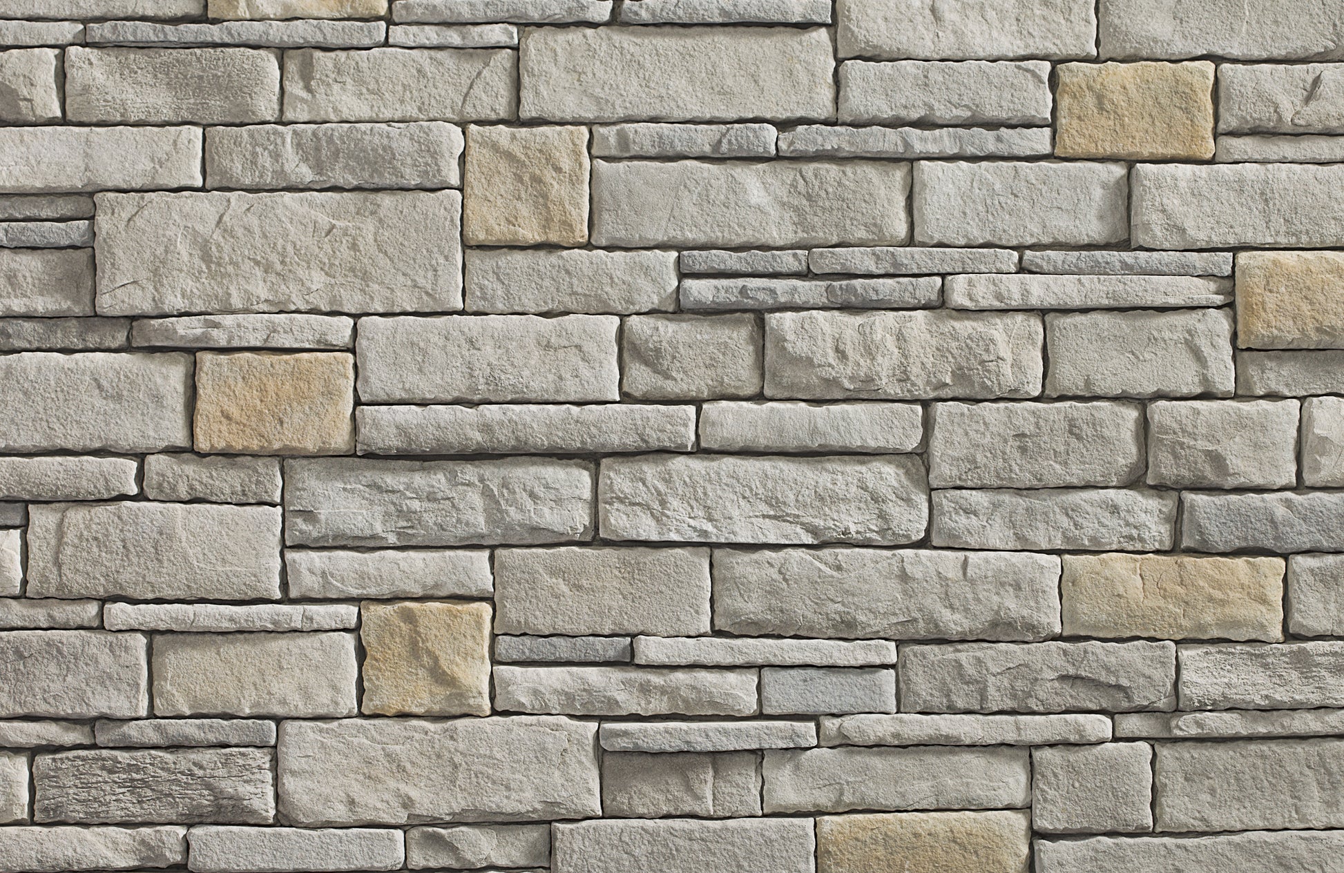 Pattern of stone bricks in various shades of gray and beige.