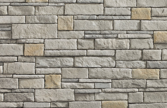 Pattern of stone bricks in various shades of gray and beige.