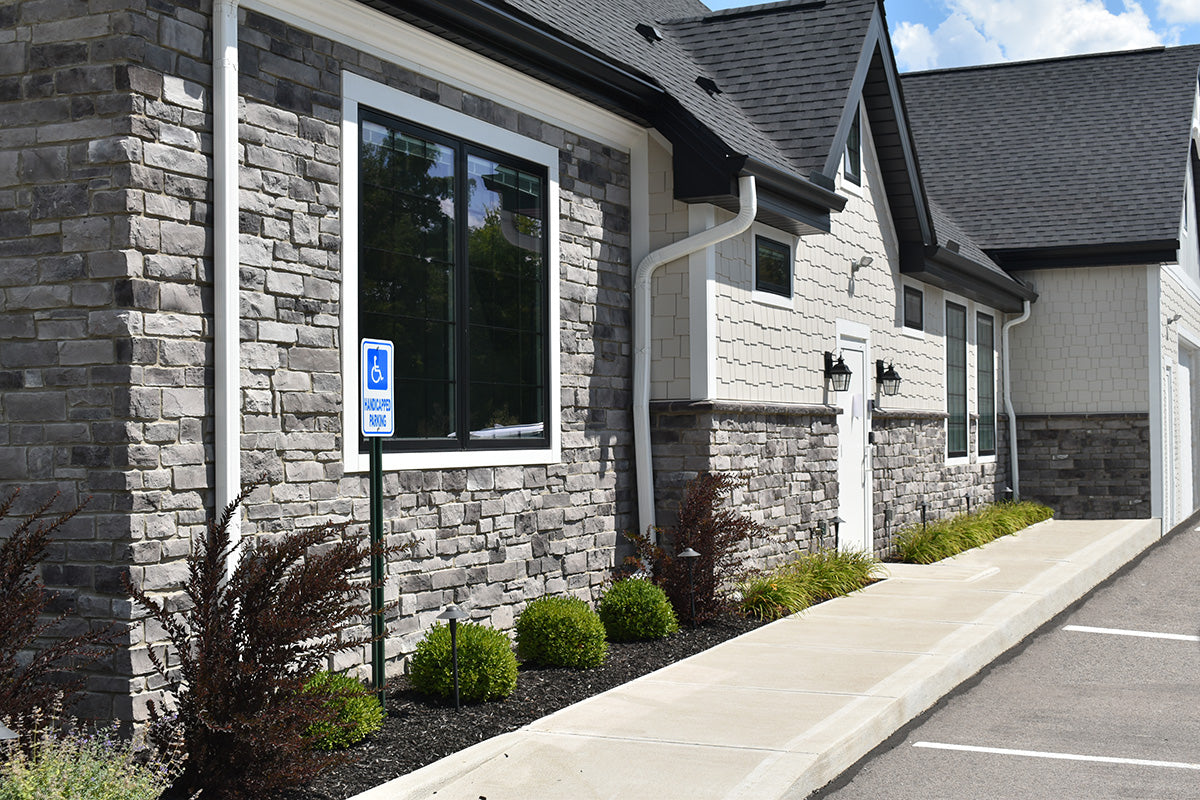 Stone building with a sidewalk and street in front