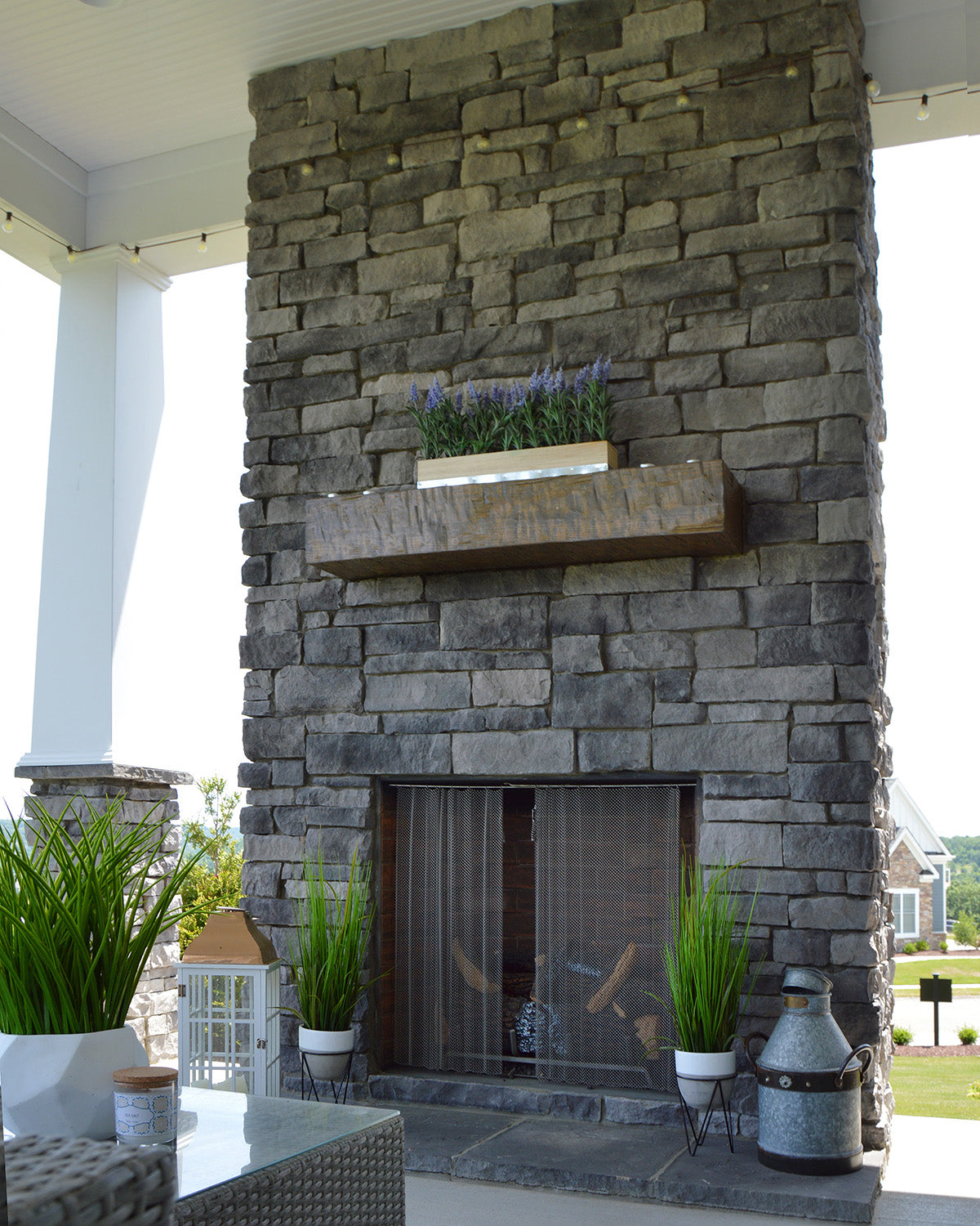 Outdoor stone fireplace with decorative elements on a patio