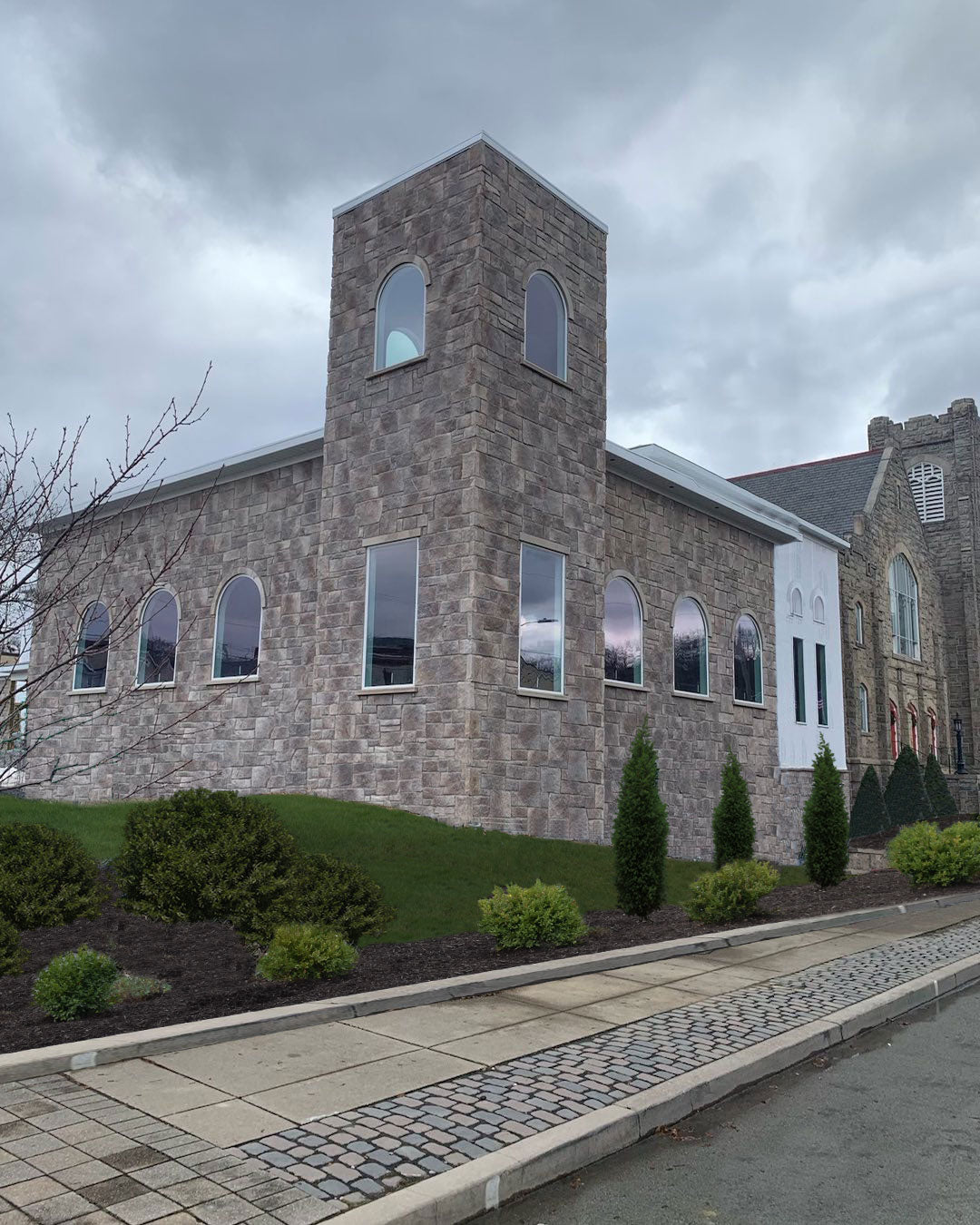 Stone building with a tower on a cloudy day