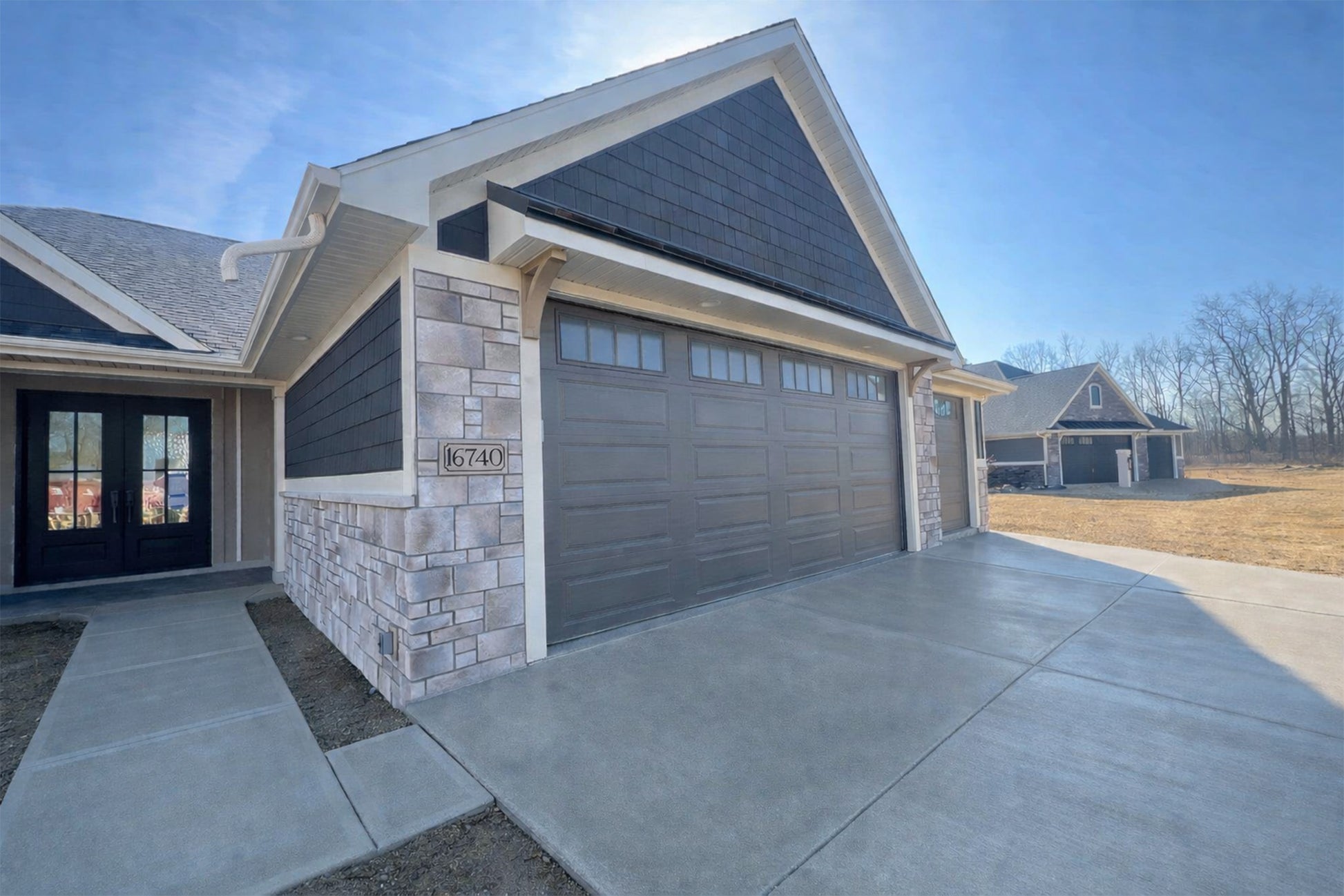 Modern house with a garage and driveway on a clear day