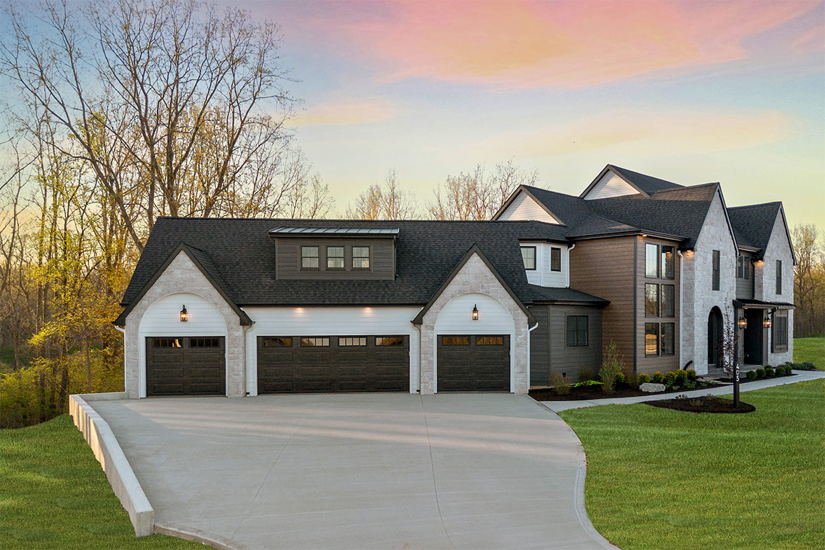 Two-story house with a large garage at sunset