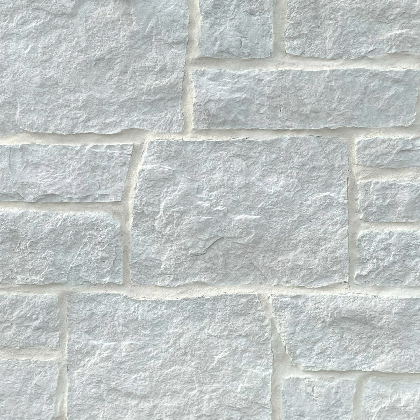 Close-up of a stone wall with white stones