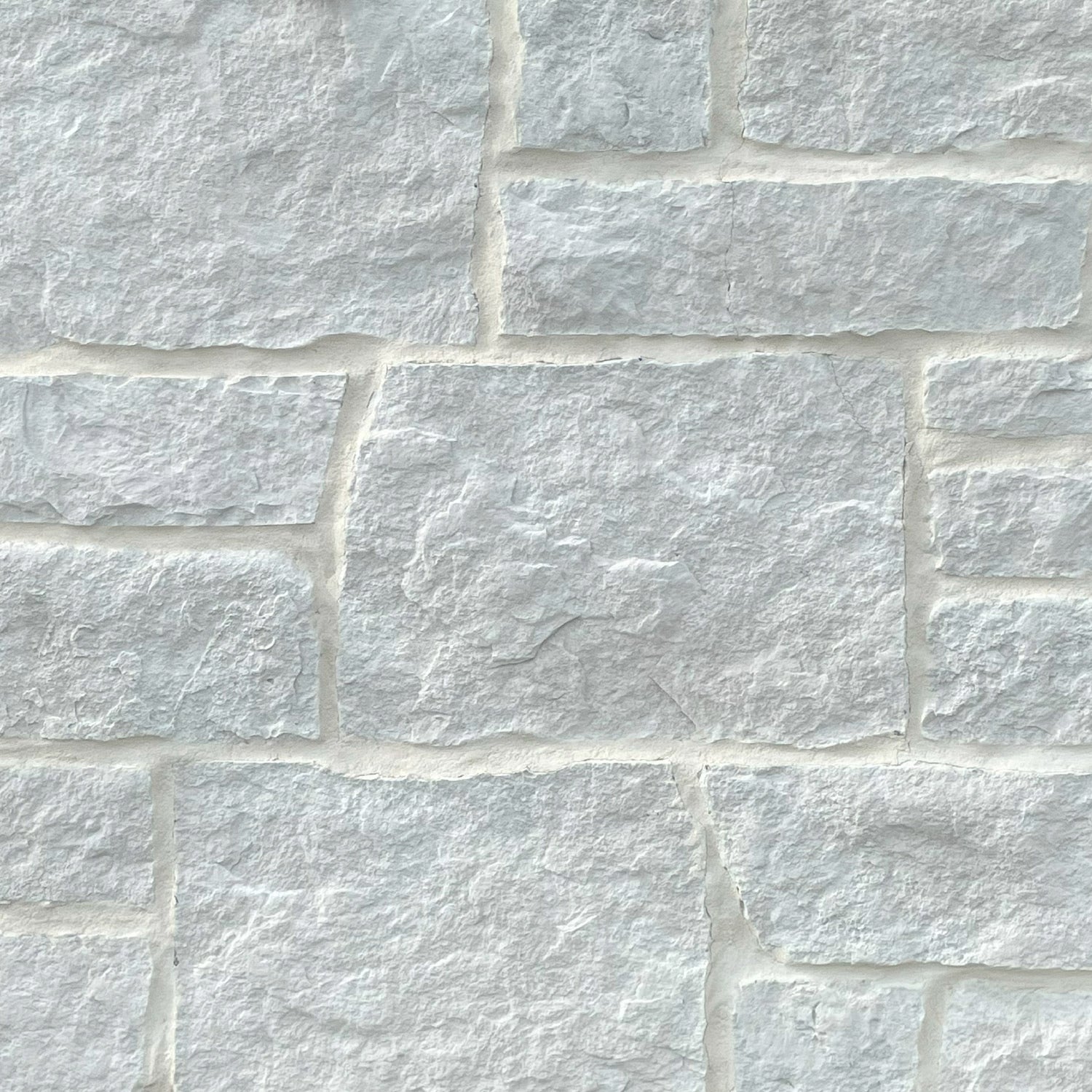 Close-up of a stone wall with white stones
