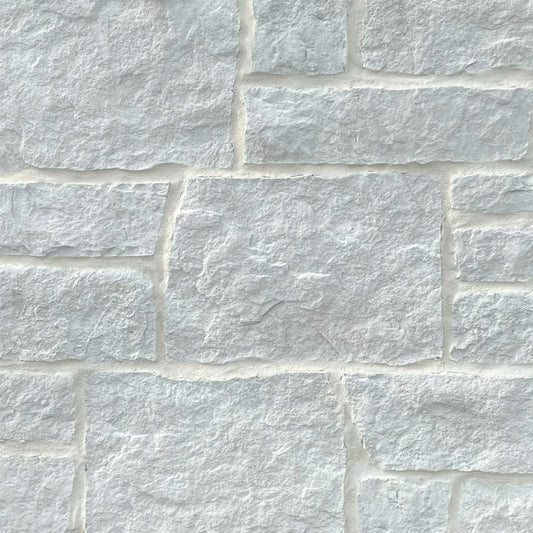 Close-up of a stone wall with white stones