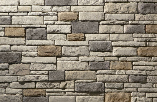 Pattern of stacked stone bricks in various shades of gray and brown.