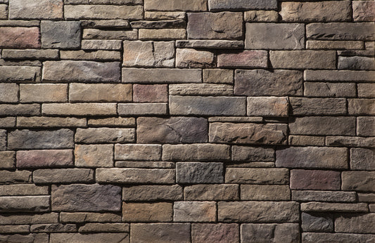 Pattern of stacked stone bricks in various shades of brown and gray.