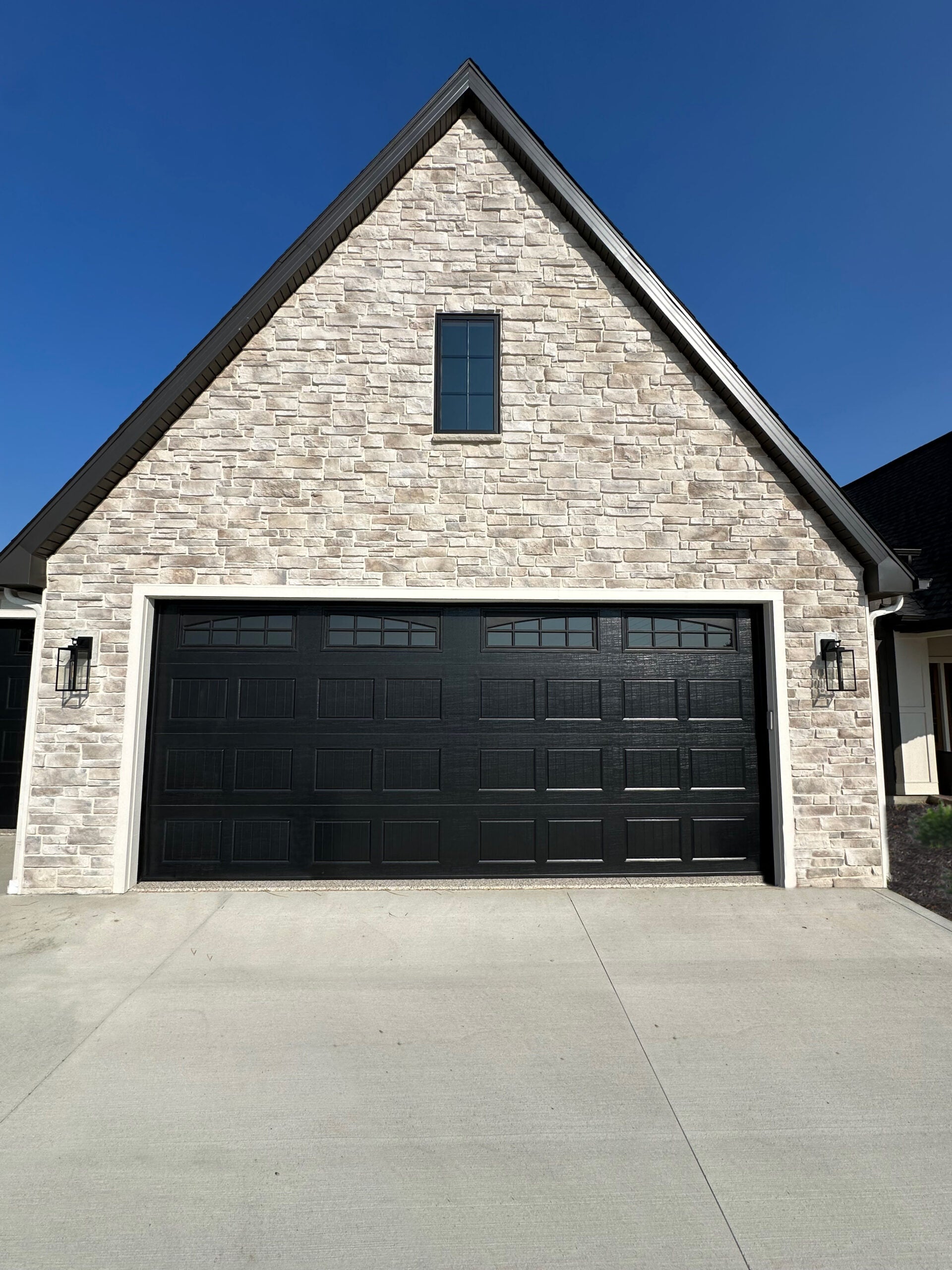 Garage door on a brick building with a clear blue sky