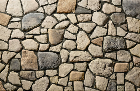 Close-up of a stone wall with various colored stones.