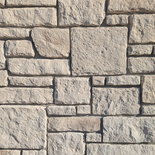 Close-up of a stone wall with beige and brown stones