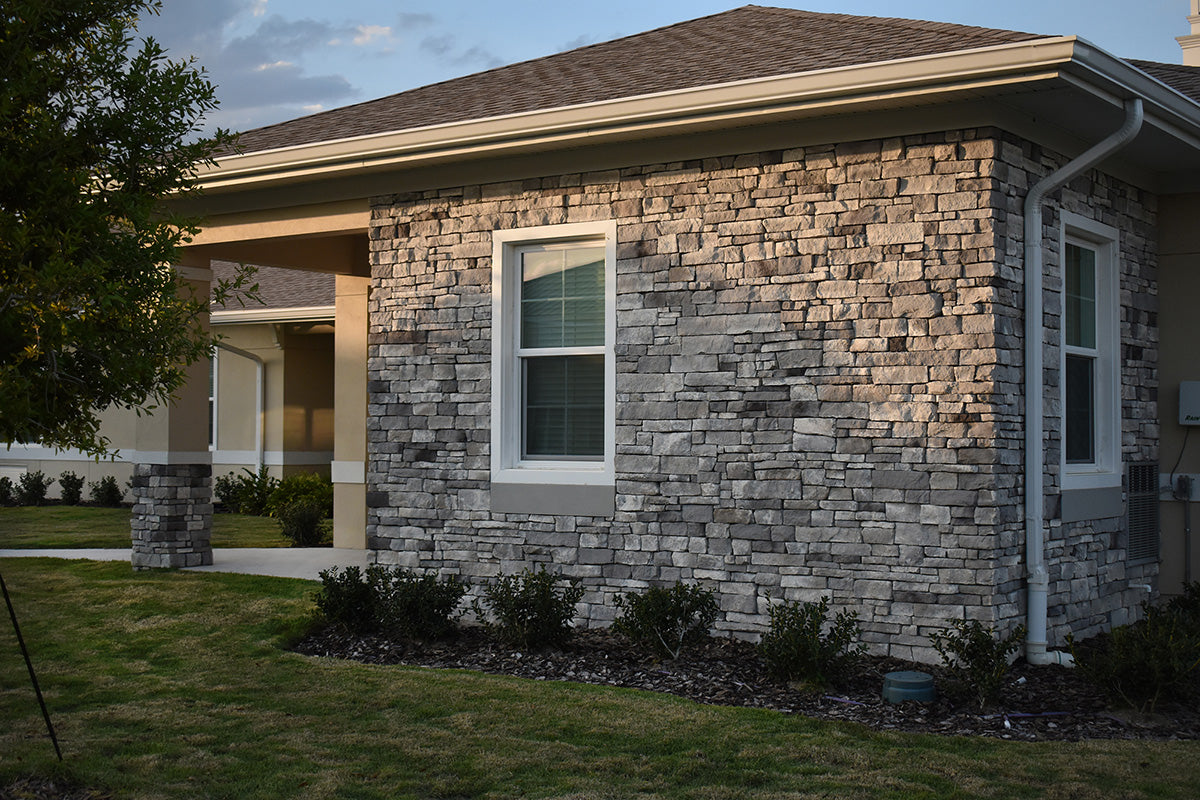 House exterior with stone facade and green lawn