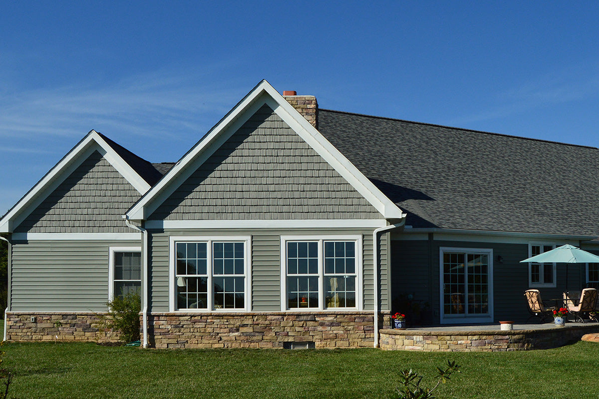 House exterior with gray roof and white trim on a clear day